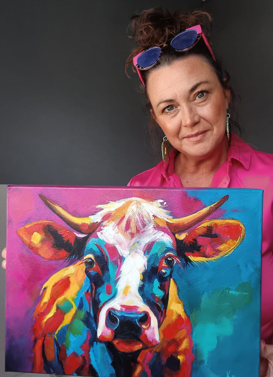 Kim Bezuidenhout in her studio holding Kim with the Horned Cow