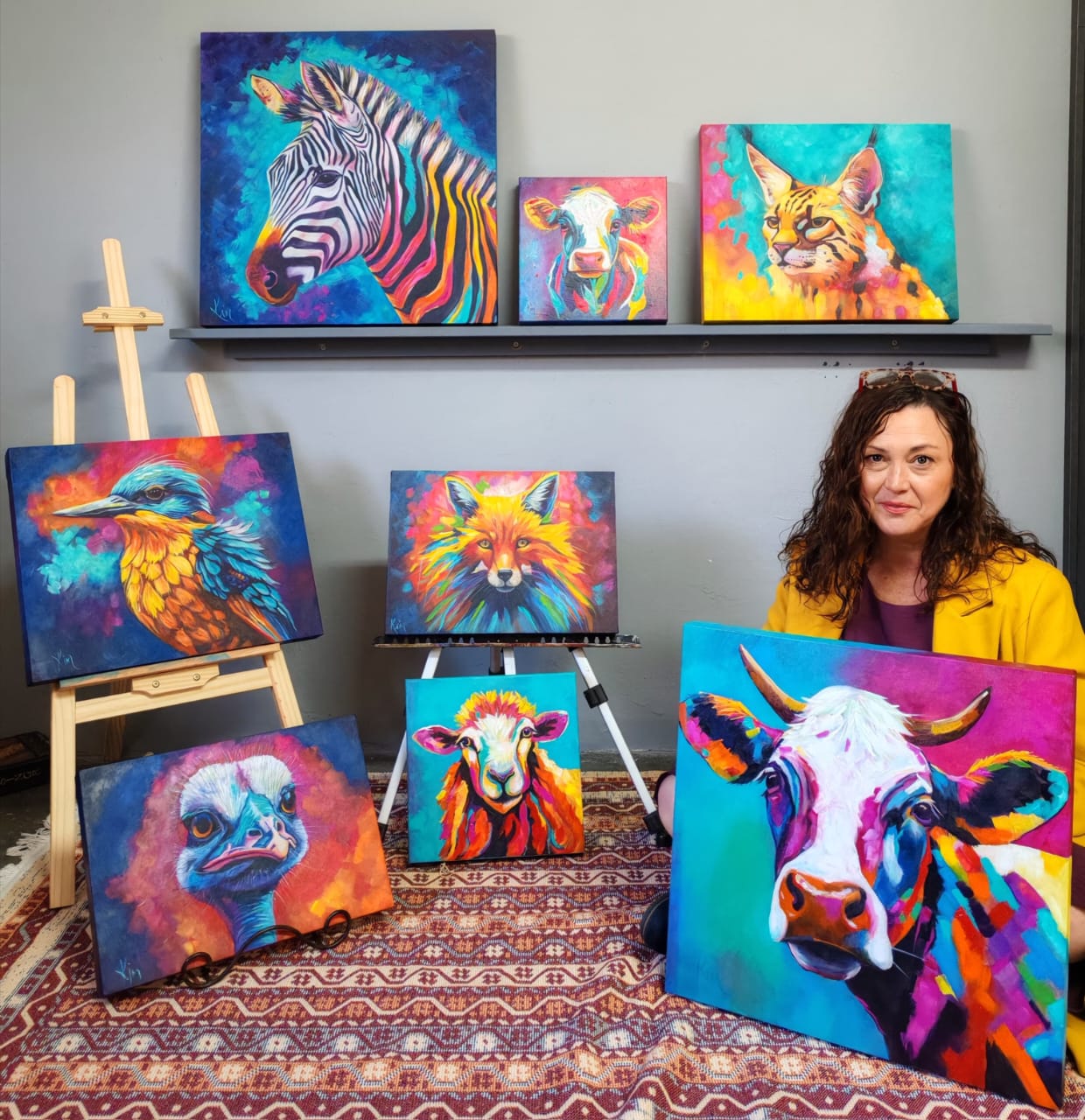 Kim Bezuidenhout with a collection of her paintings