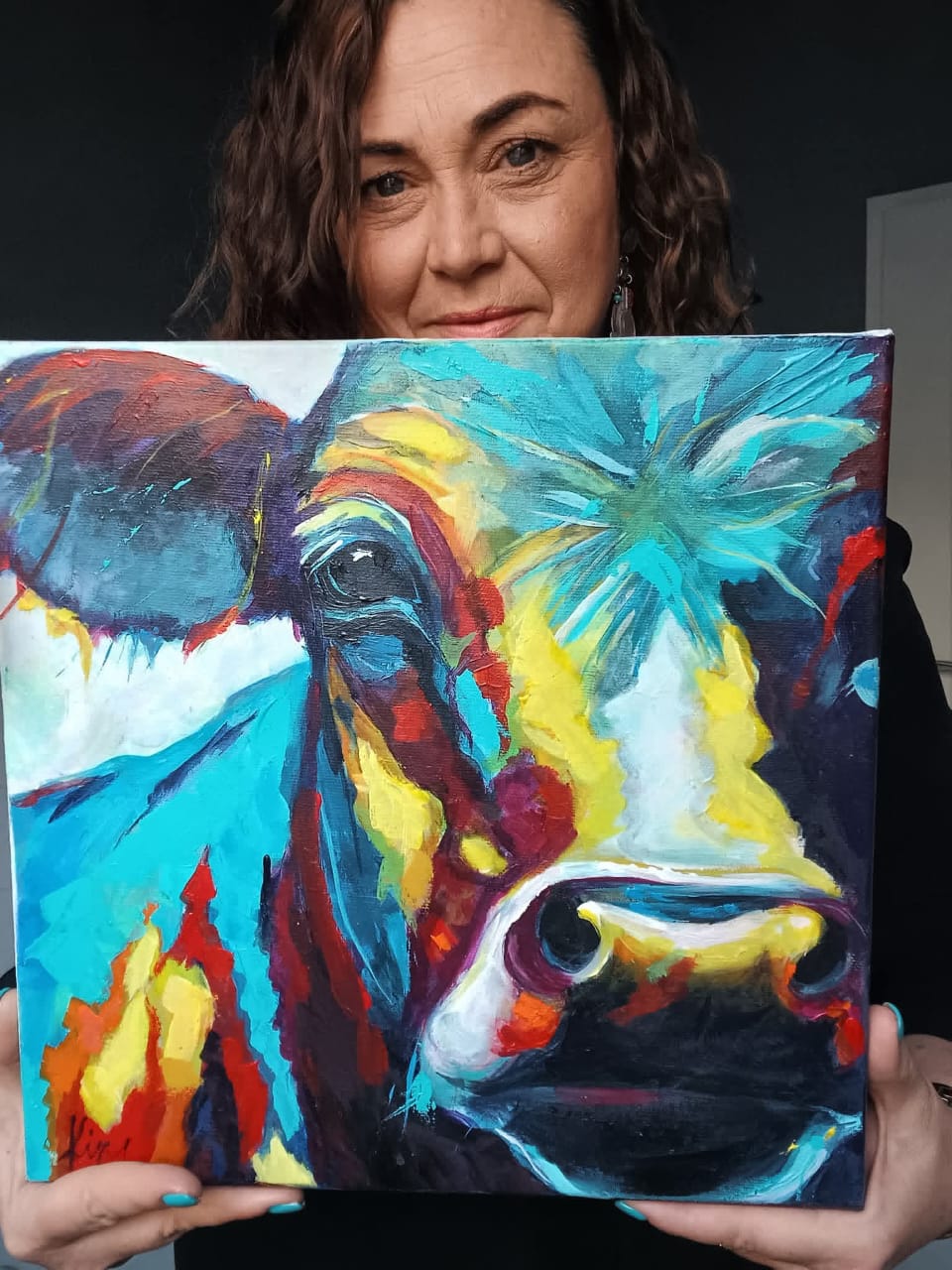 Kim Bezuidenhout in her studio holding Kim with the Cow Close-Up