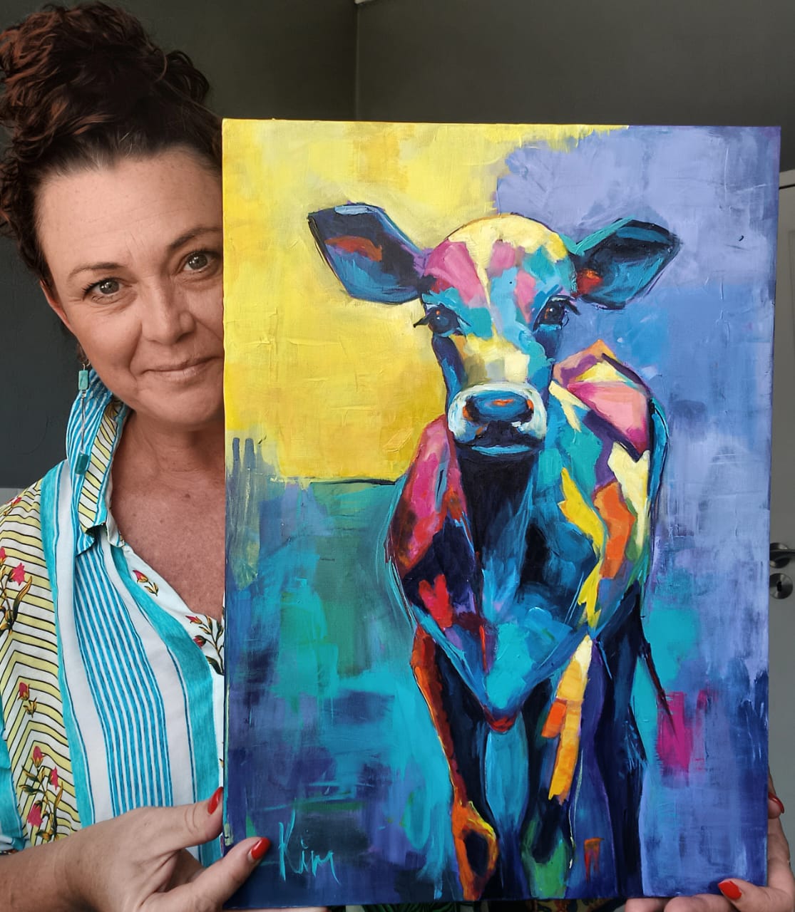 Kim Bezuidenhout in her studio holding Kim with the Blue Calf