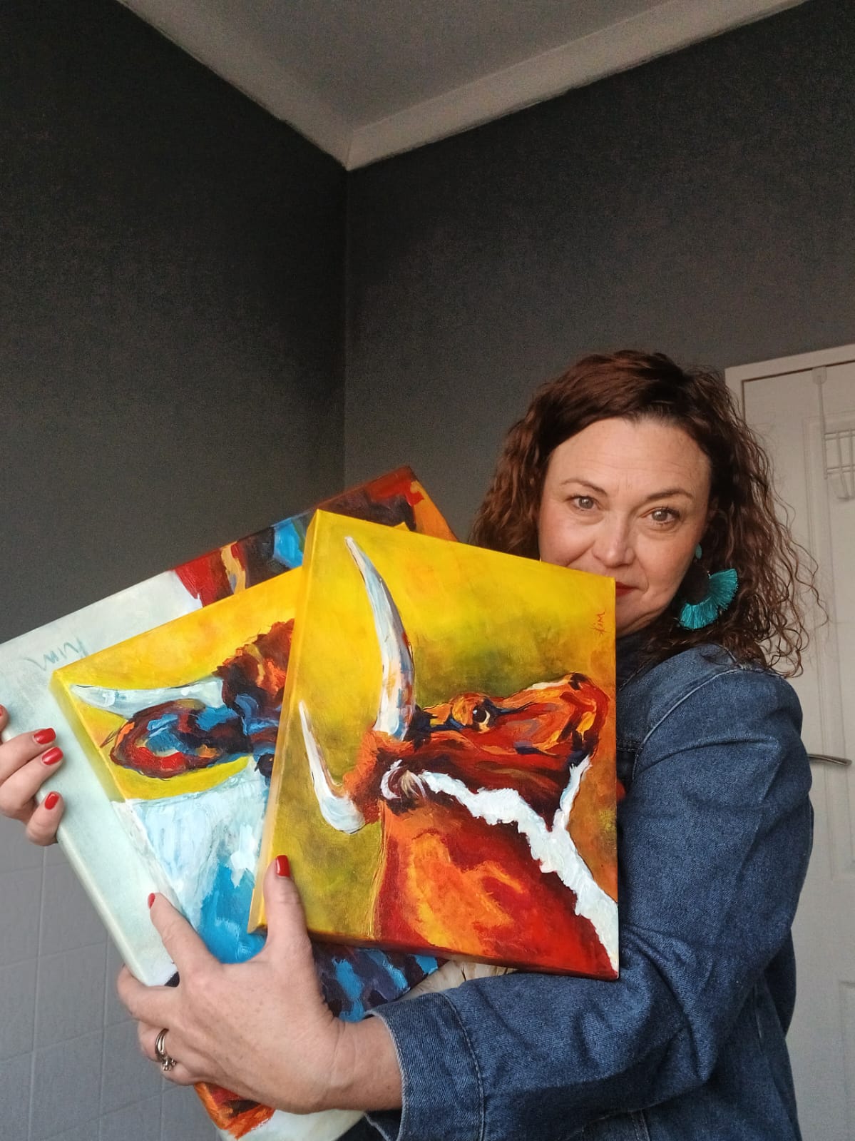 Kim Bezuidenhout in her studio holding Kim with the Nguni Pair