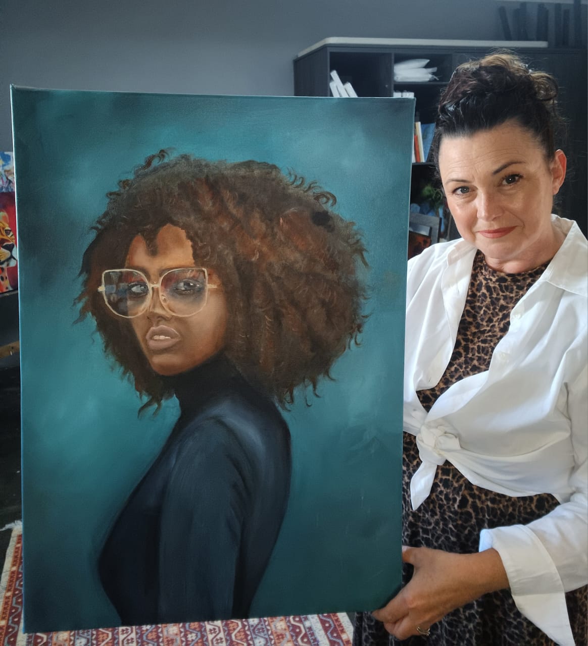 Kim Bezuidenhout in her studio holding Kim with the Afro Portrait